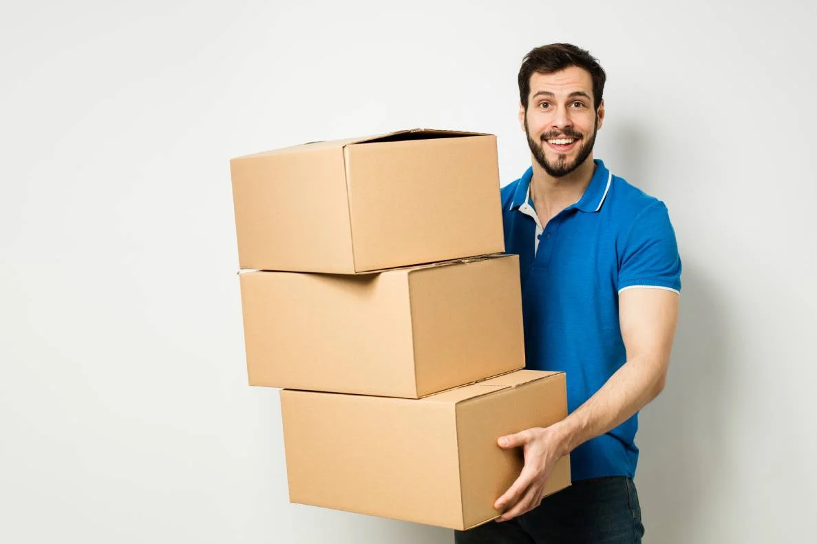 man holding moving boxes